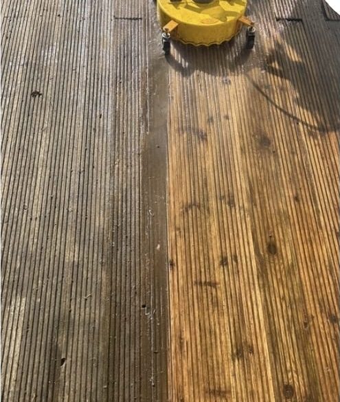 Decking half cleaned, showing the colour difference